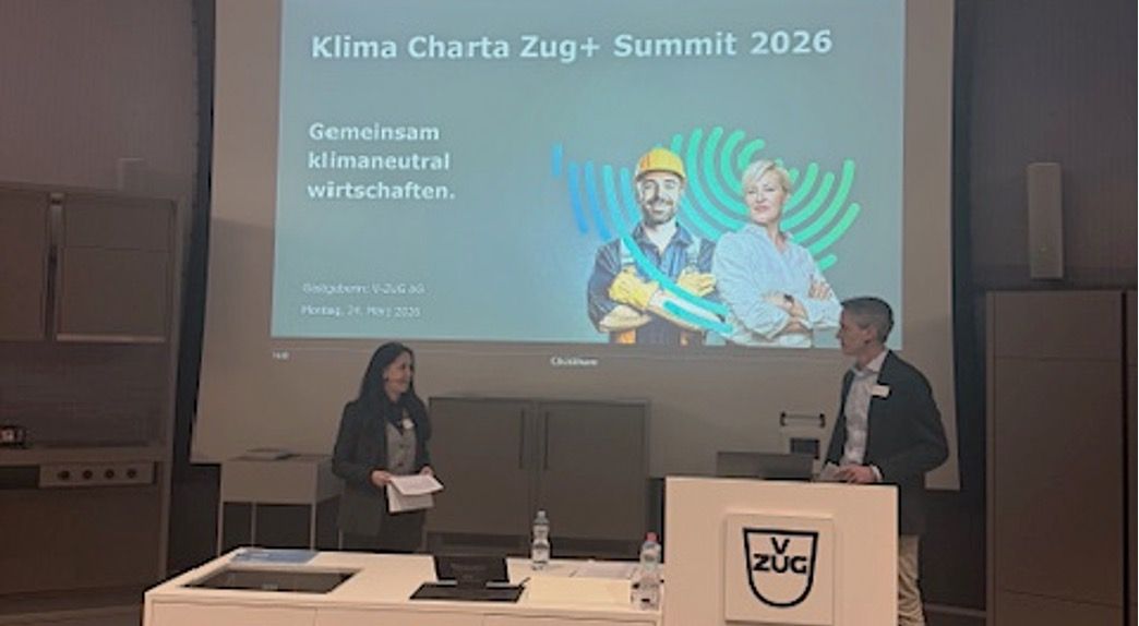 Speaker presenting at Climate Charter Zug+ Summit 2026 at V-ZUG, discussing climate-neutral business operations and sustainability initiatives